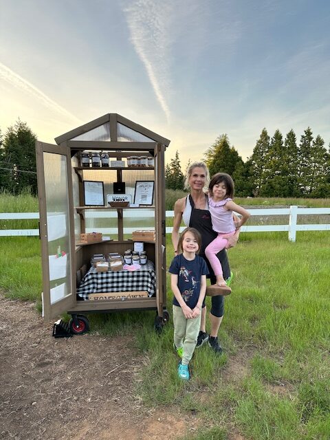 Notting Hill Farm's Farm stand with the owner and her daughters